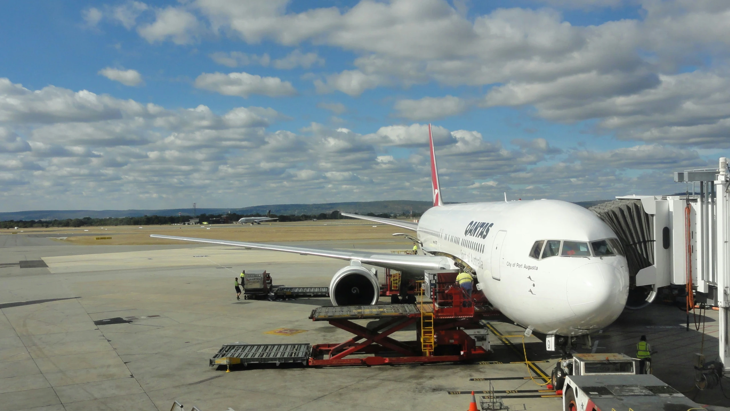 an airplane getting boarding on the runway of an airport