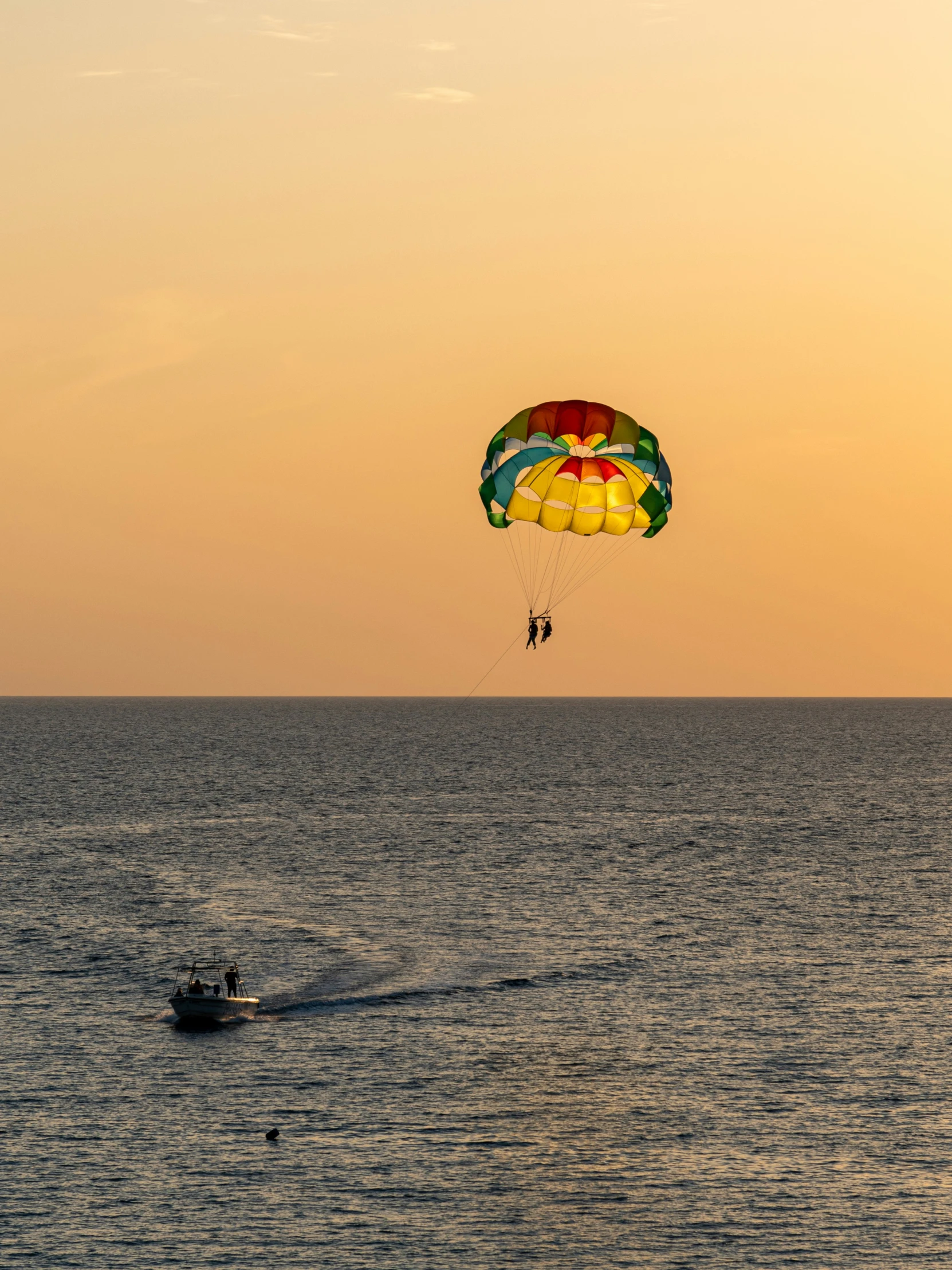 a man para sailing on top of the ocean