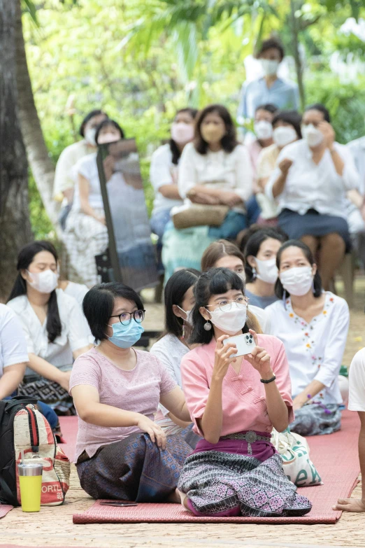 several people with face masks at an outdoor event