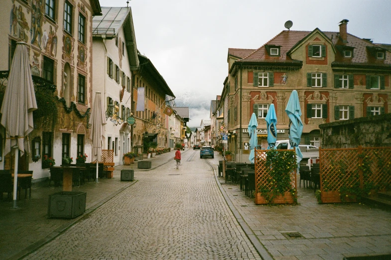 an empty cobblestone street with many houses