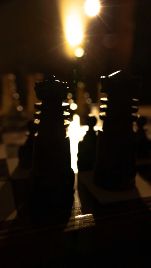 the light shining on some chess pieces