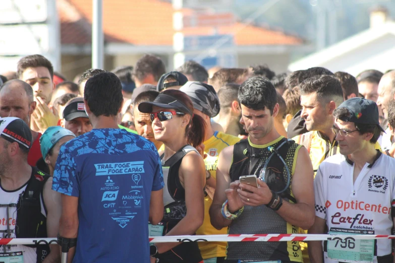 people standing in the middle of a road using cell phones