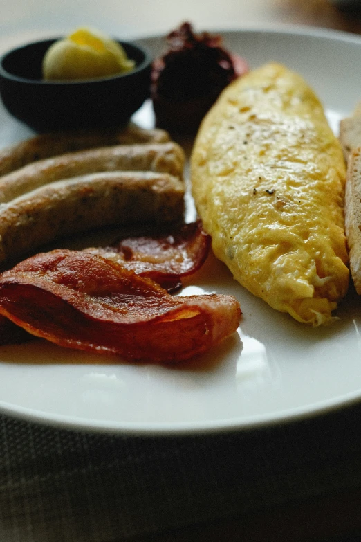 there is a white plate filled with breakfast food