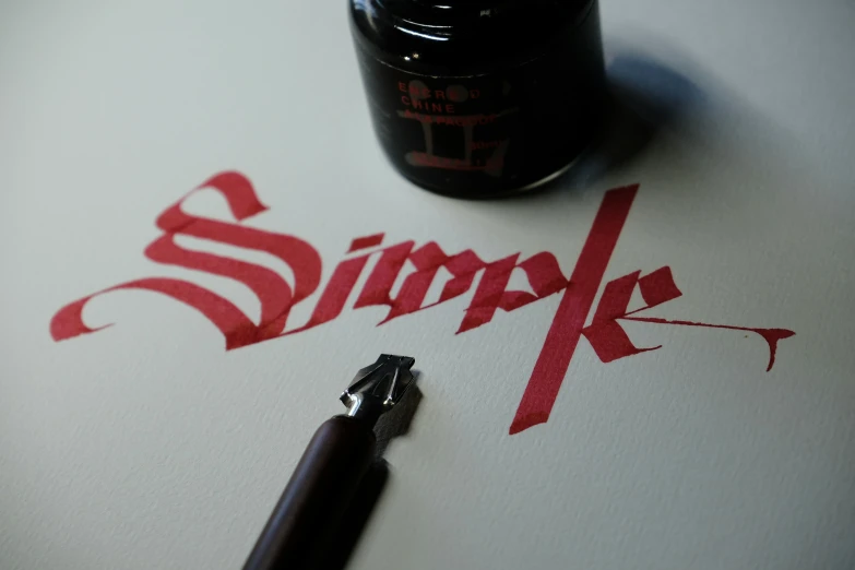 the word simke written on the paper next to an ink pen