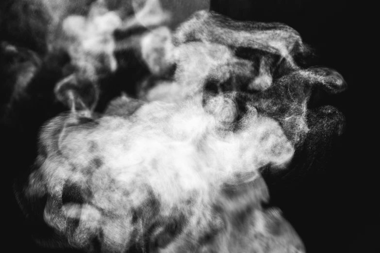 a group of smoke on top of a black surface