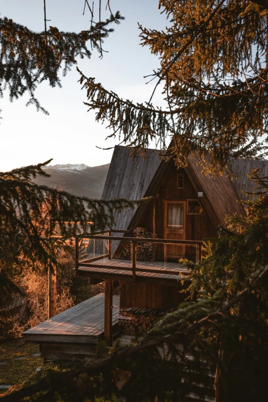 an old log cabin with trees in front of it