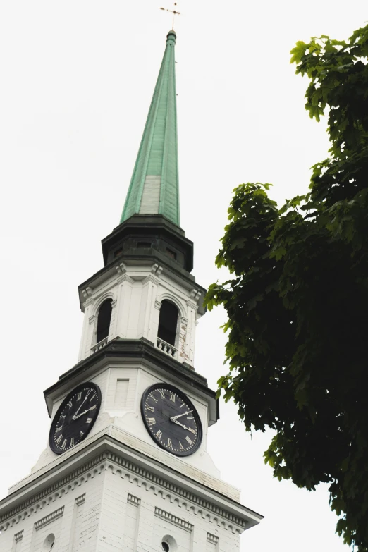 this is a clock tower with a cross on top