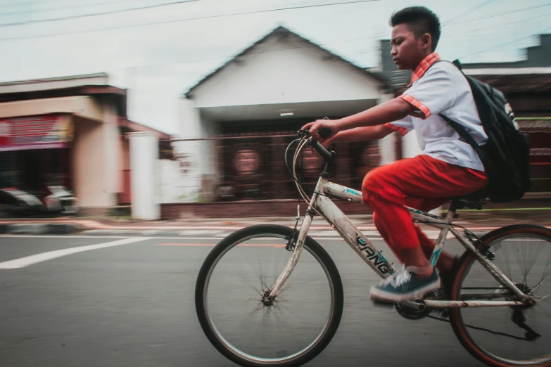 the man is riding his bicycle on the road