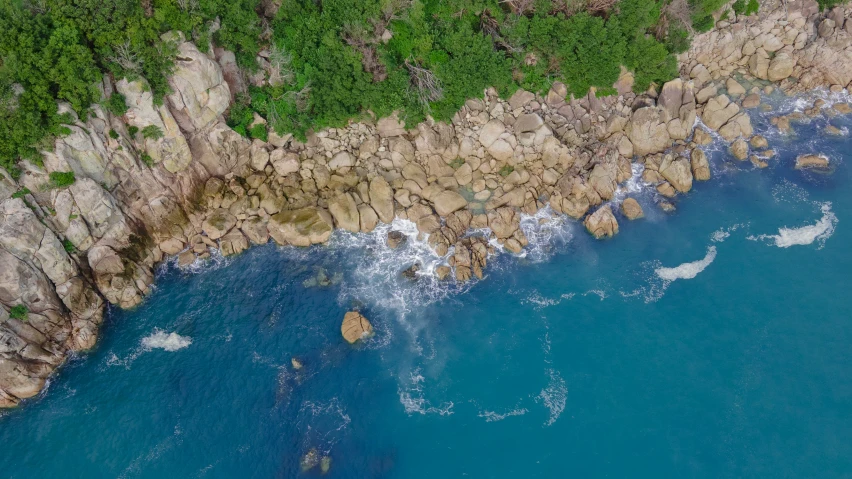 an aerial s of the rocky coast and blue water