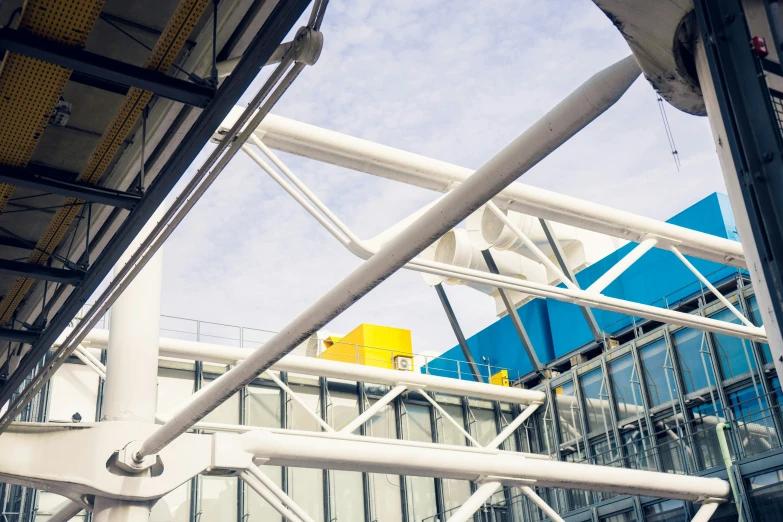 a very tall blue building with some metal bars and poles in front