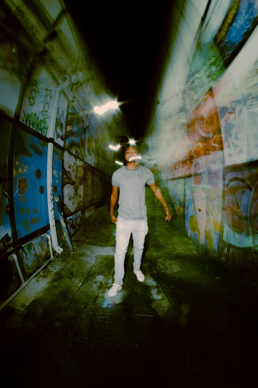 a person standing in the middle of a room with graffiti