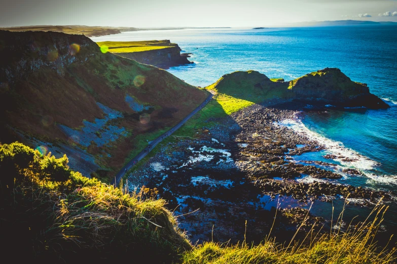 looking down at an area of grass, rocks, and water