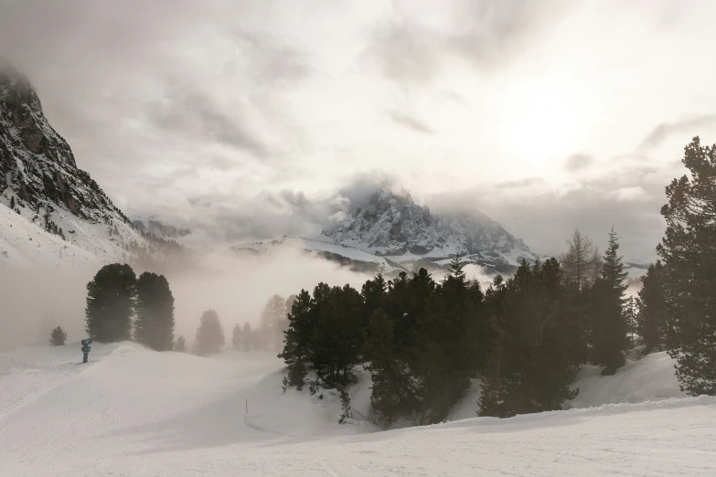 skier in the snow at sunset on a mountain