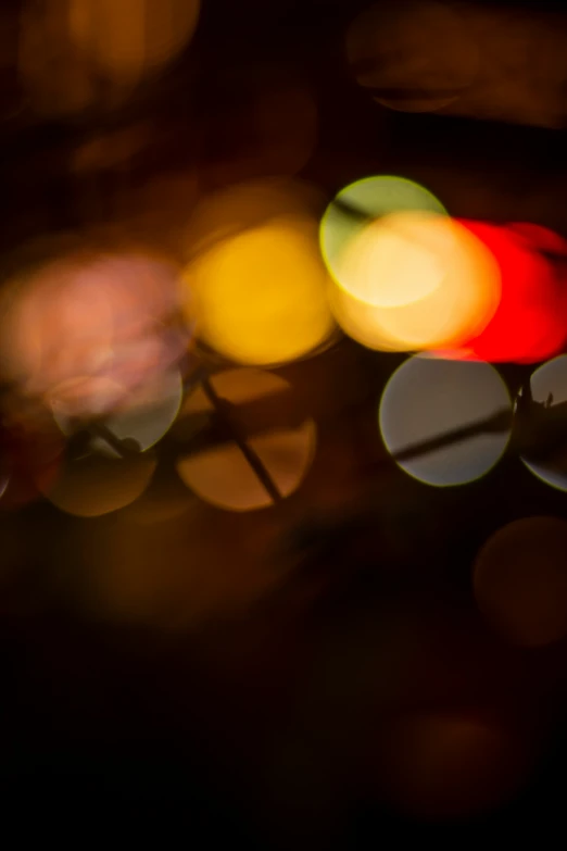 colorful traffic lights that are reflecting off the mirror