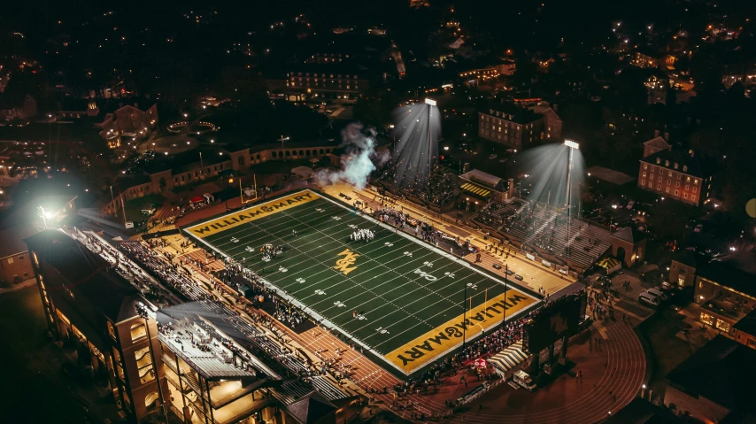 an aerial view of a football field at night