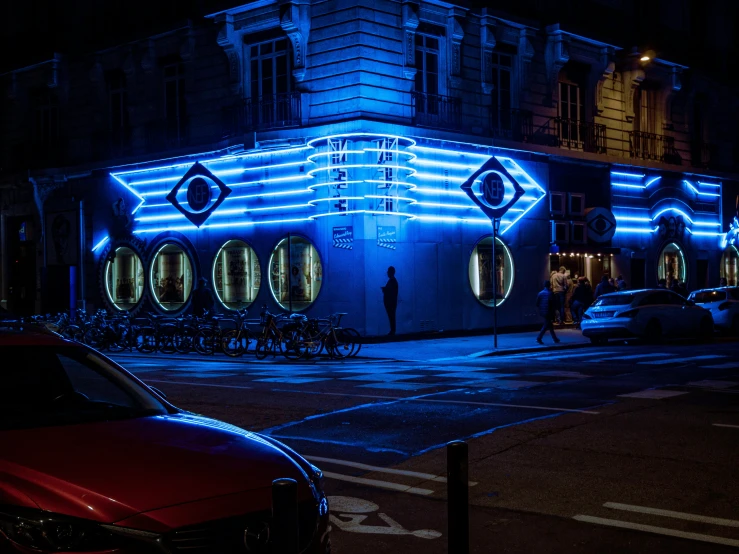 a building decorated with blue lights in the street
