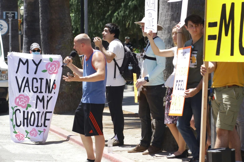 several people holding signs that read my  my choice and a sign that says my  my choice