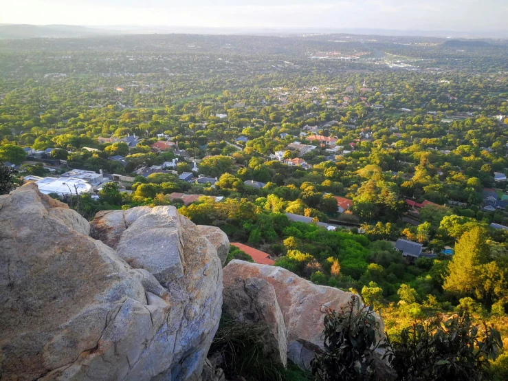 the city view from top of a large rock cliff