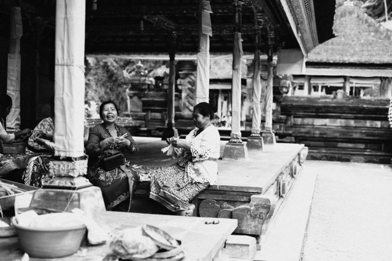 a group of women sitting at a table near some jars