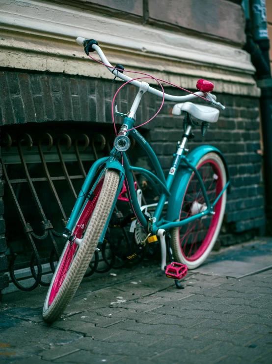 a bike locked up against the wall of a building