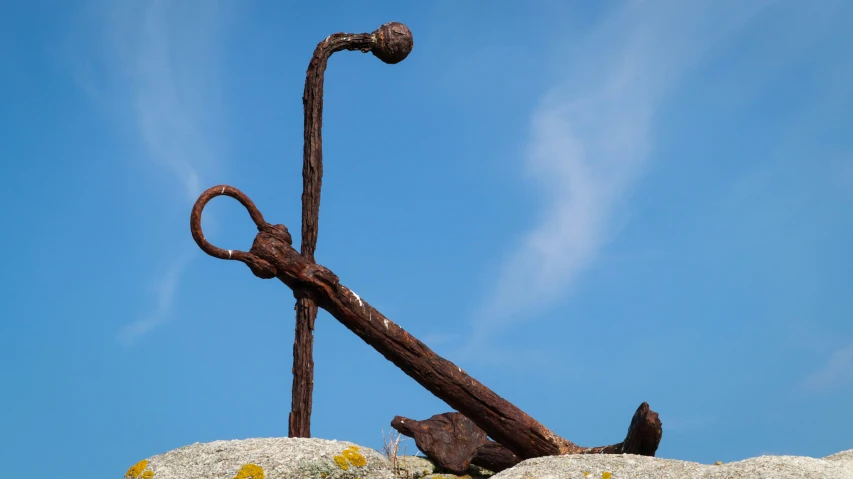 an anchor on a rock with a clear sky in the background