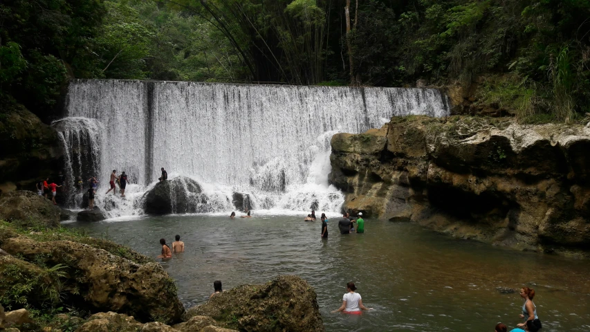 many people gather in a body of water to swim in