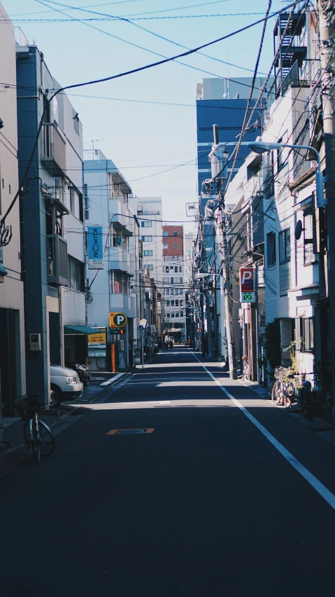 a street with a lot of cars on it and a person on a bike