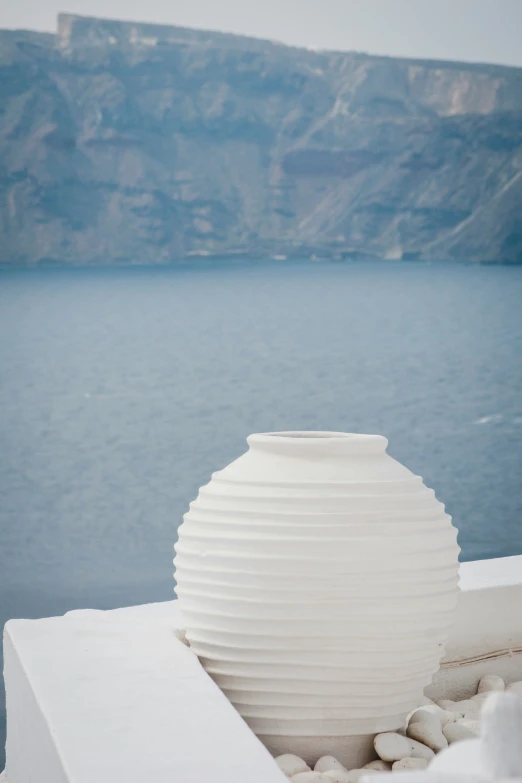 a large white vase that is on the side of a building