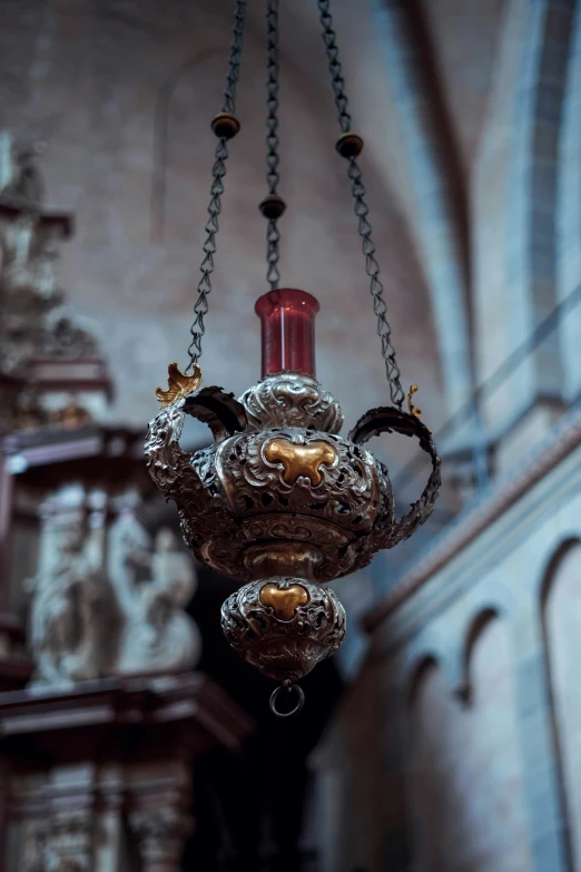 silver hanging vase and chandelier in a large room