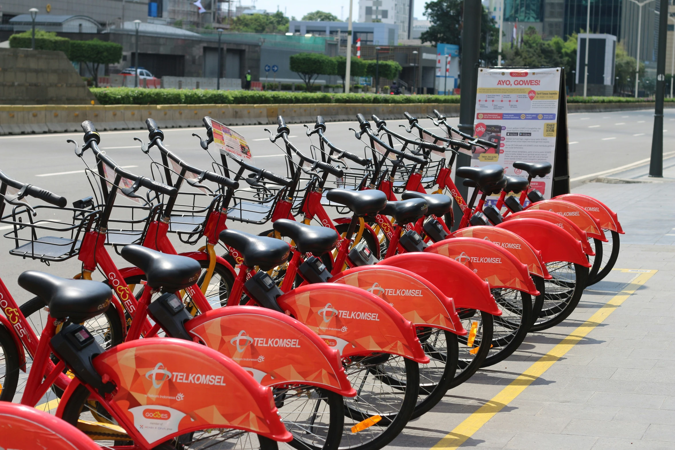 a row of bikes parked along side the road