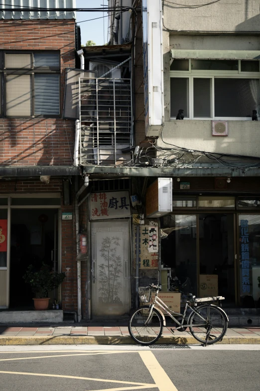 a building with a ladder and bike parked in front of it