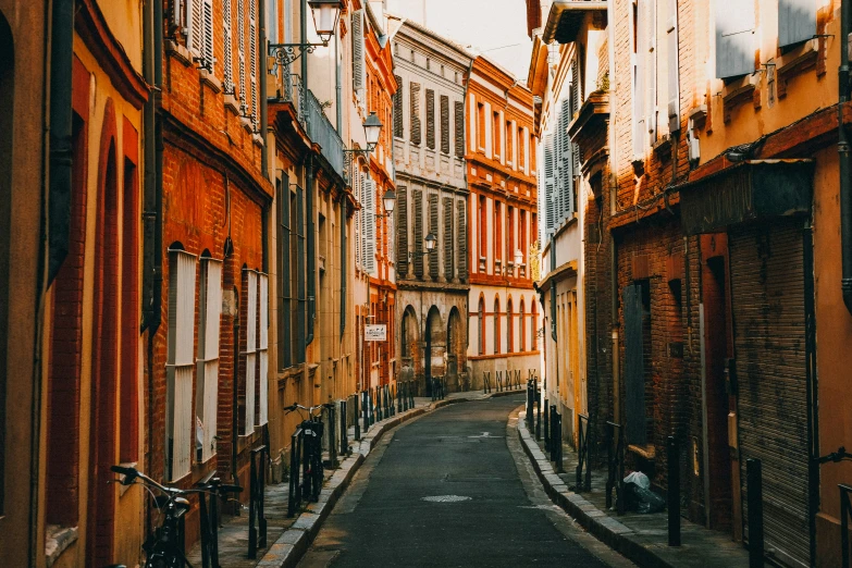 there is a narrow and long street between two buildings