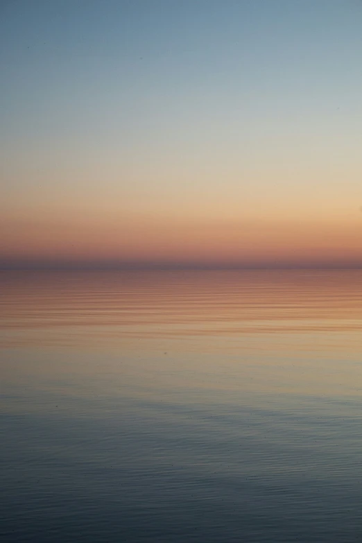 water under an orange sky at sunset or dusk