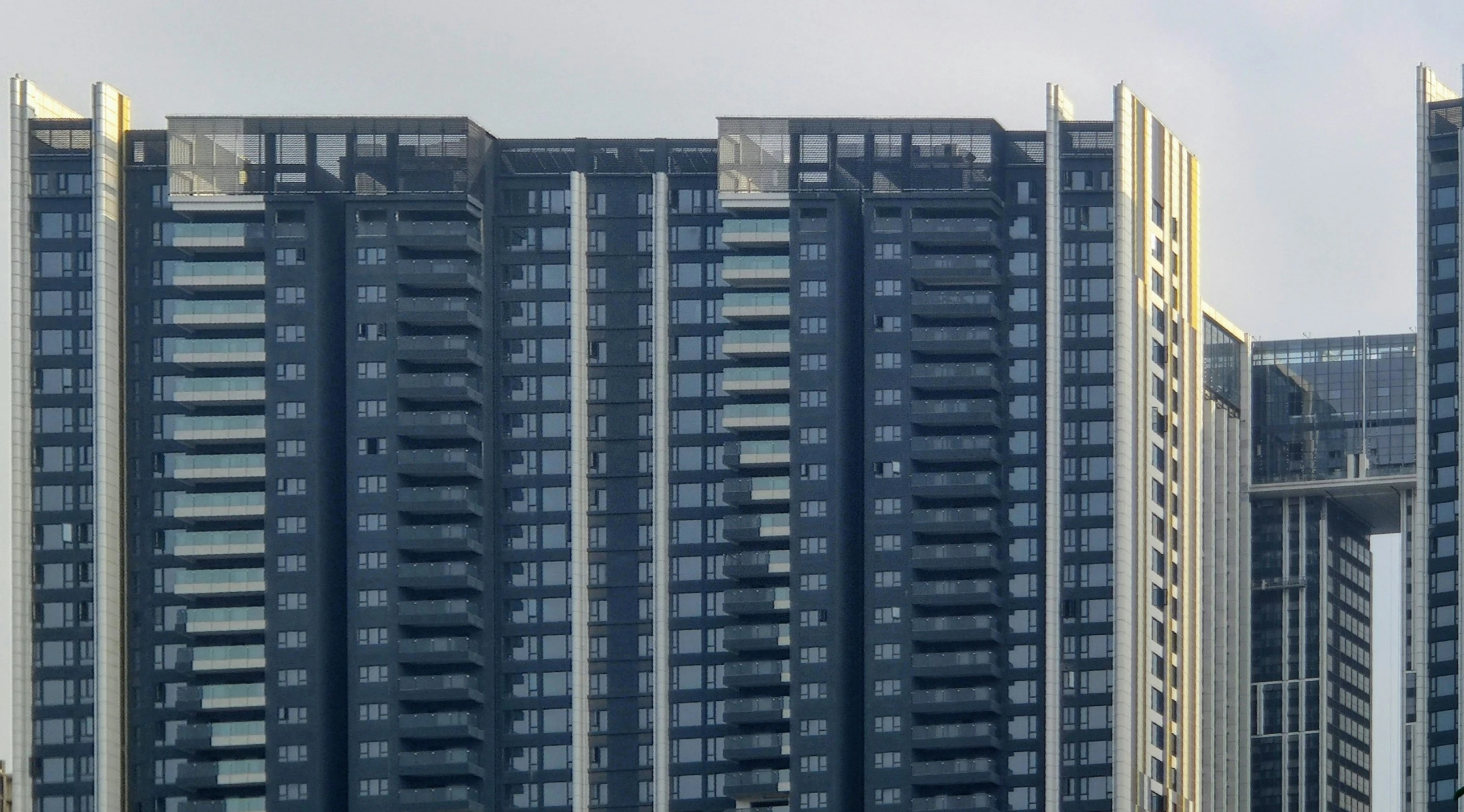 three skyscrs that are sitting side by side