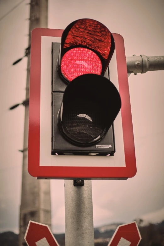 the stop light is red and ready to go down the street