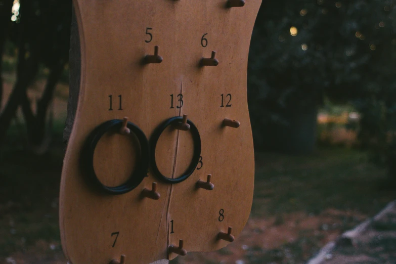 a clock made out of cardboard with some rings and numbers