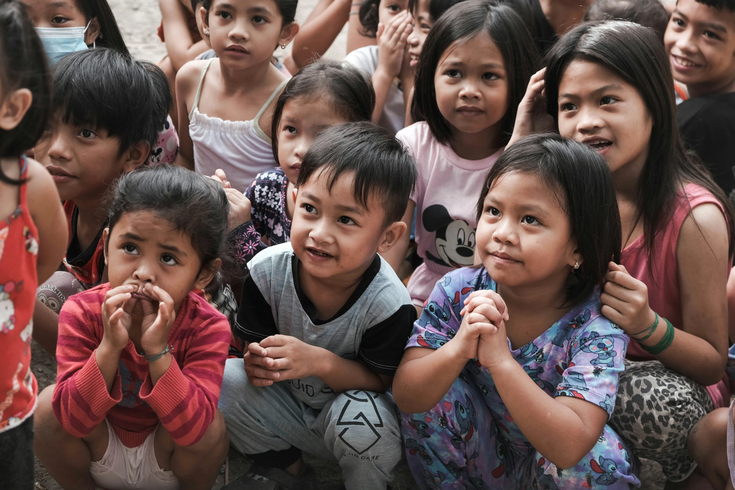 many little children sit next to each other