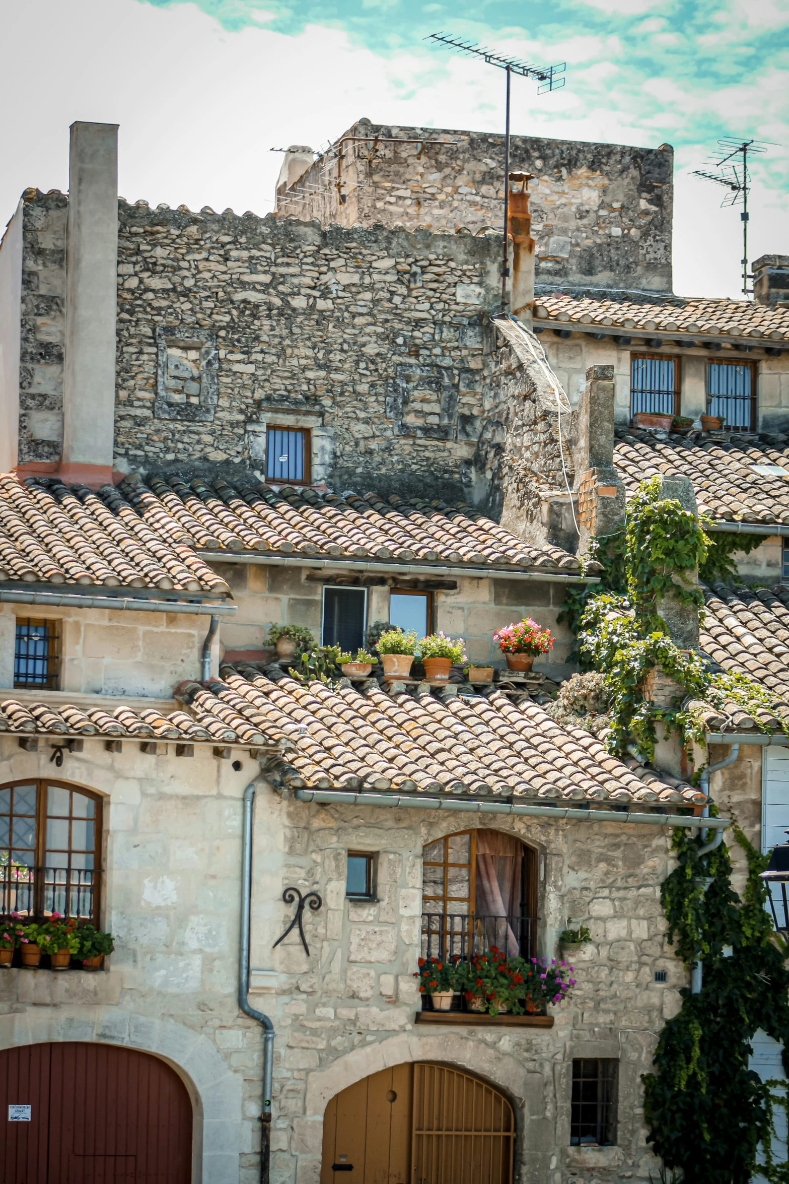 several old house with stone chimneys and brown doors