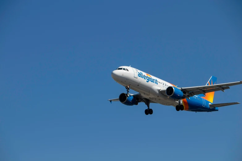 a white airplane in flight with its wheels up