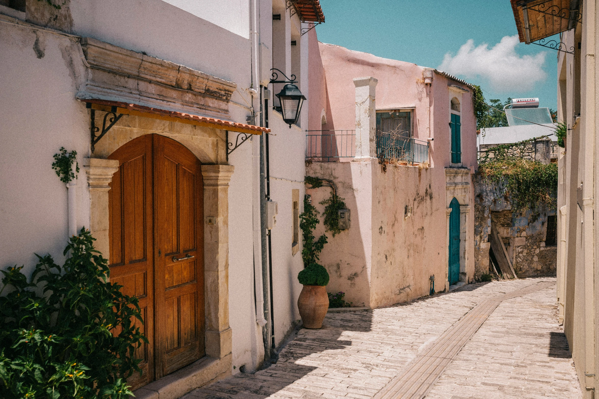 an alley way in a foreign country has wooden doors