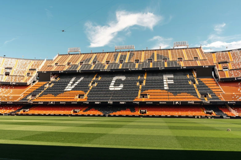 empty stadium seats against a blue sky with kites in the air