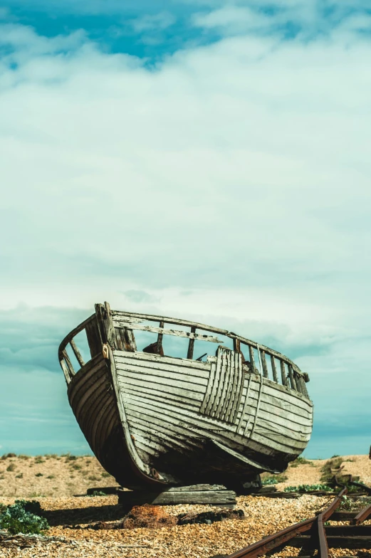 a wooden boat on land on the beach