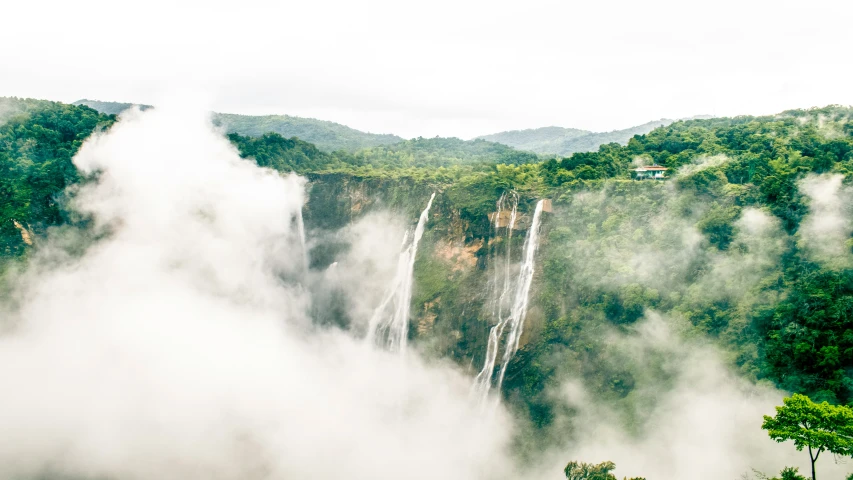 a view of a waterfall in the forest