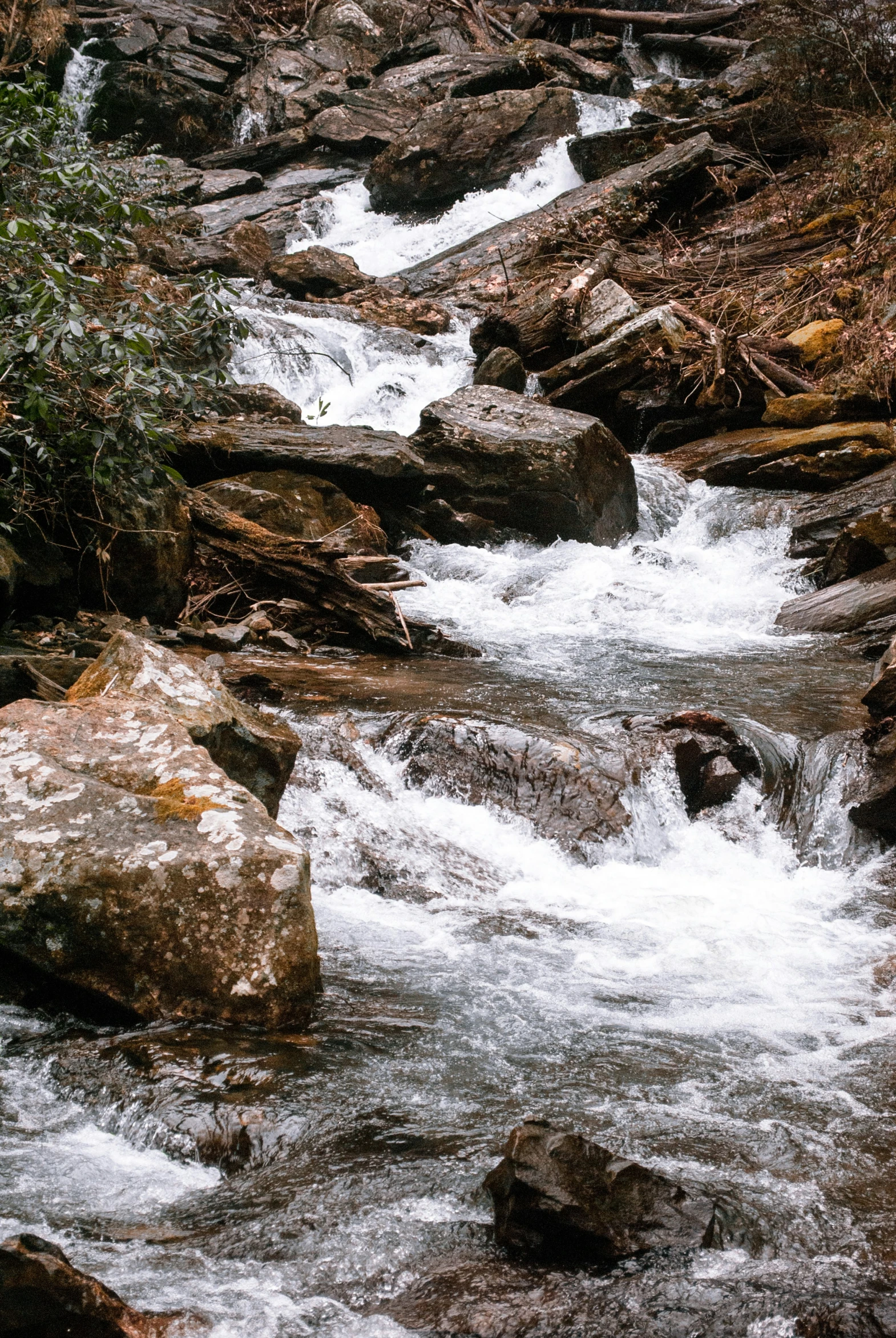 an image of a beautiful waterfall going down the mountain stream