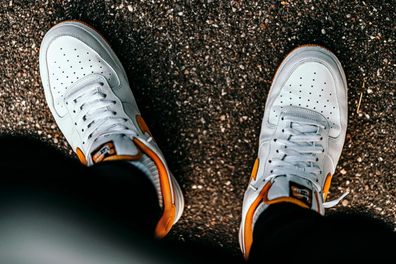 white and orange shoes with dark colored socks