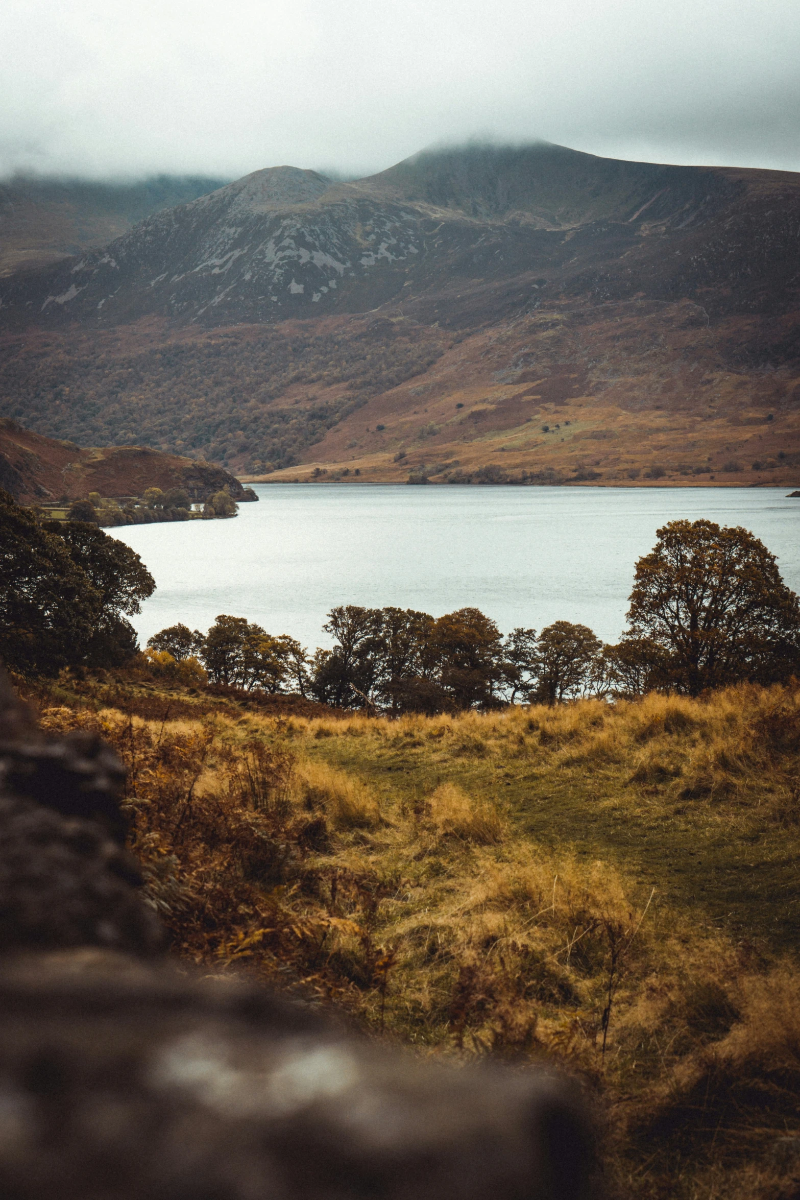 the view looking across a mountain at a lake