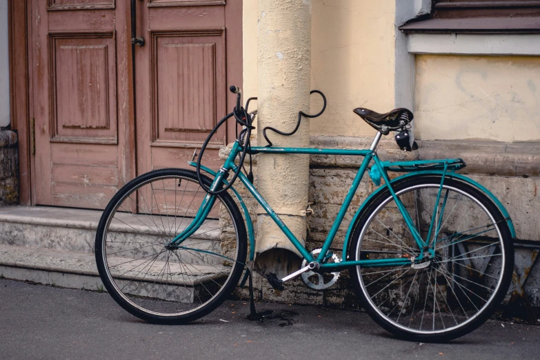 a bicycle leaning against a building next to an old door