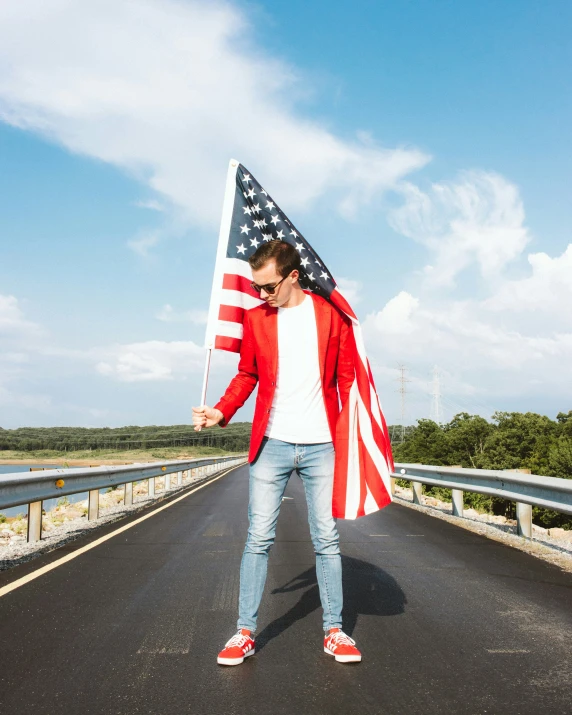 a man is holding an american flag