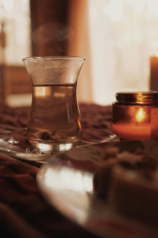 a candle and teapot on a table