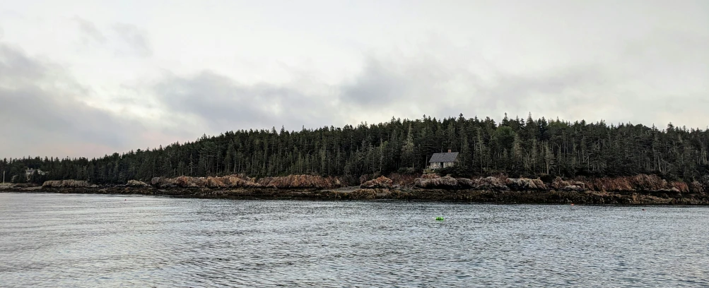 a boat moving on the water near an island with trees